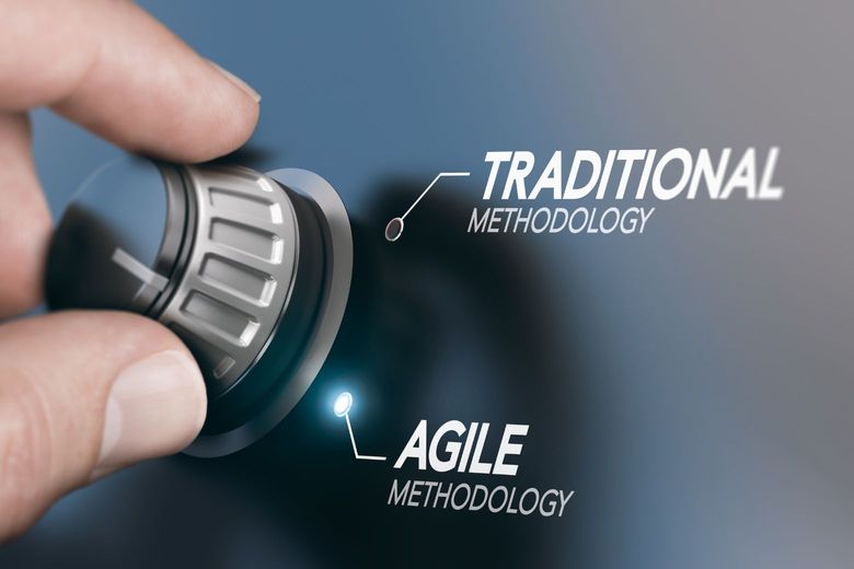 hand switching a dial from traditional to agile methodology